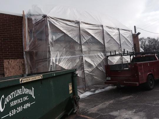 Stacked Stone Installation that has been tented using scaffolding and a heat source to allow for a cold weather installation